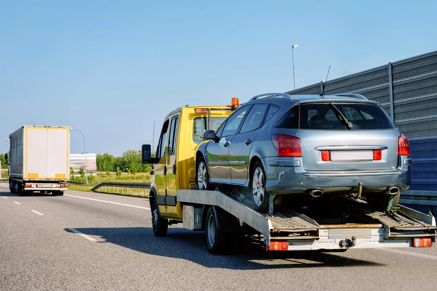 Car being towed on the motorway