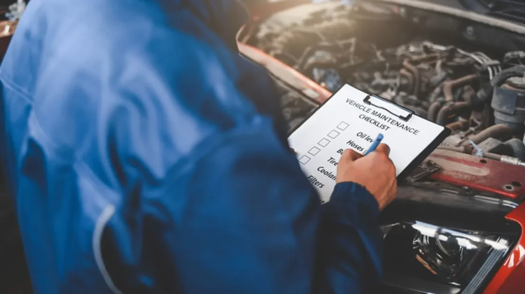 someone doing a vehicle maintenance checklist